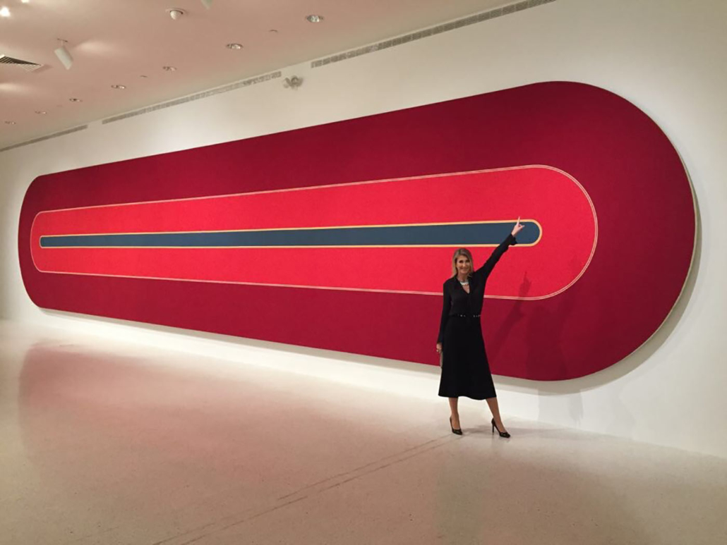 Alexandra Humbel standing in front of a painting by Franck Stella at NSU in Fort Lauderdale, Florida