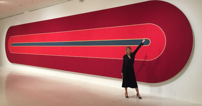Alexandra Humbel standing in front of a painting by Franck Stella at NSU in Fort Lauderdale, Florida